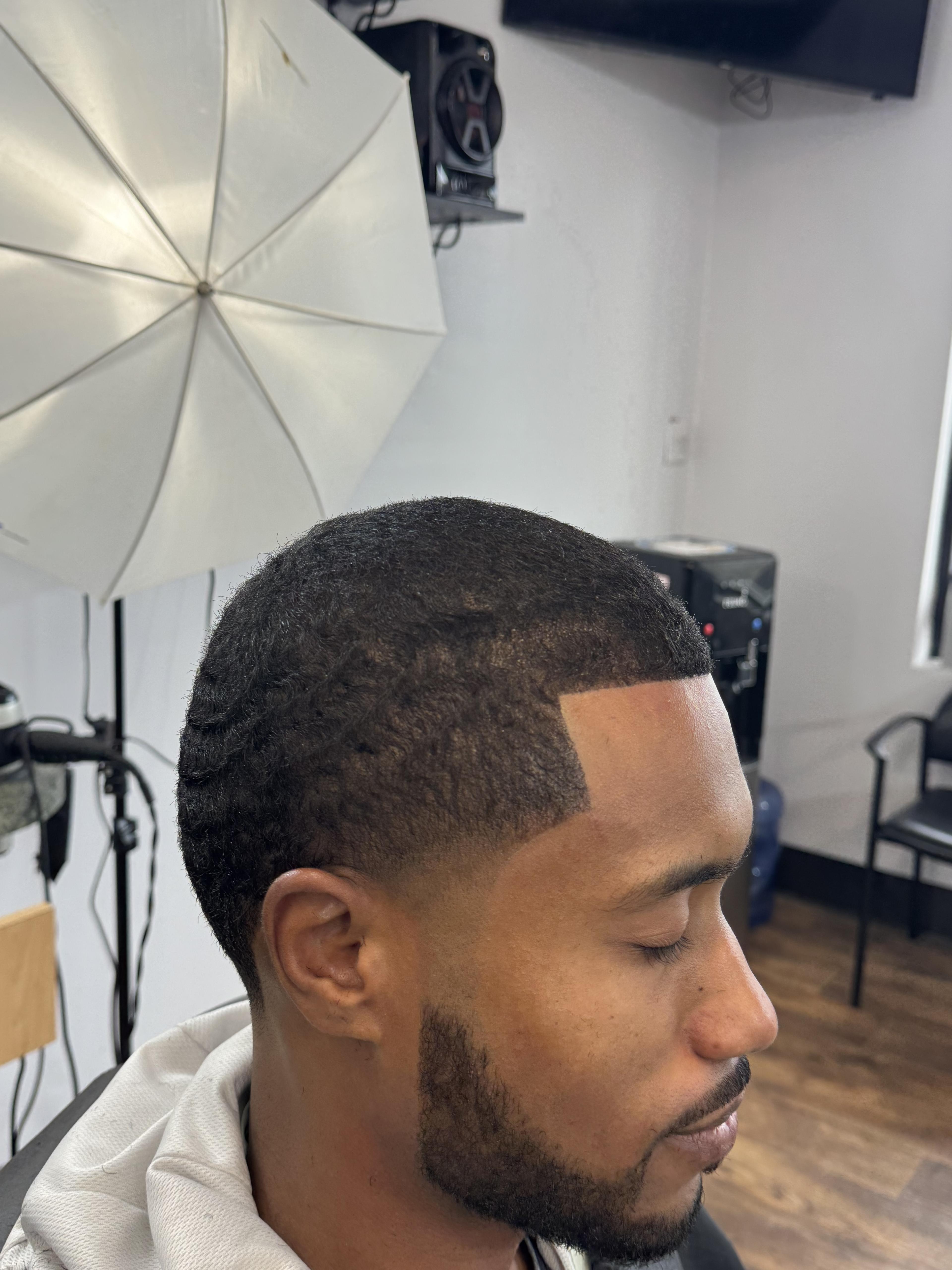 Client haircut with a sharp front lineup and beard detail