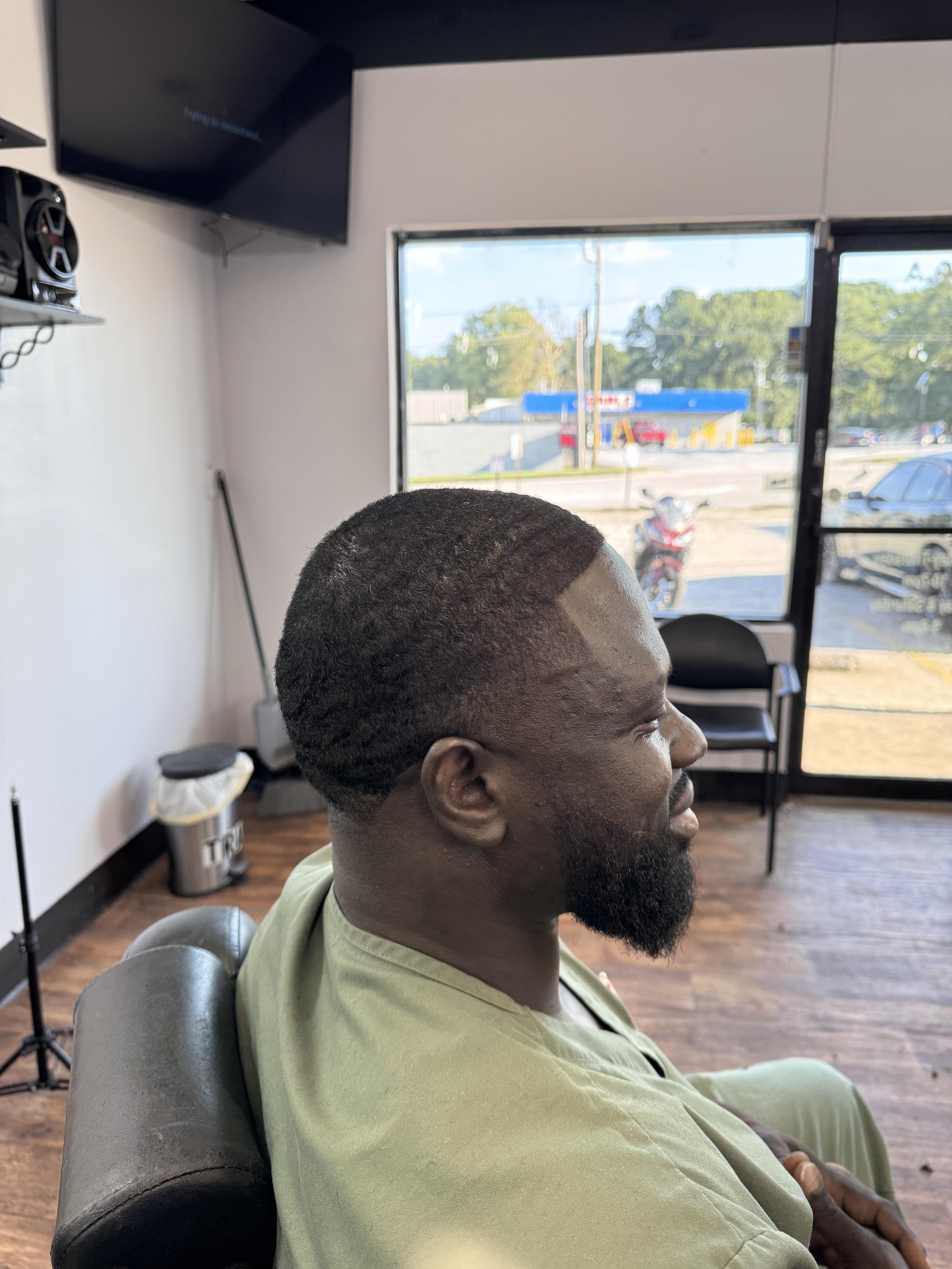 Client wave haircut with tapered side and clean edge